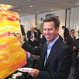 SSG software chief Dan Skiles makes his creative contribution to an advisor-crowdsourced painting.