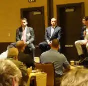 Shirl Penney (l.) and Elliot Weissbluth (middle) take their turns listening as Rudy Adolf (r.) explains his firm's impressive M&A feats.