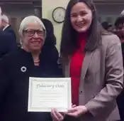 Sheryl Garrett poses with DOL's Phyllis Borzi and the Fiduciary Oath from the Committee for the Fiduciary Standard.